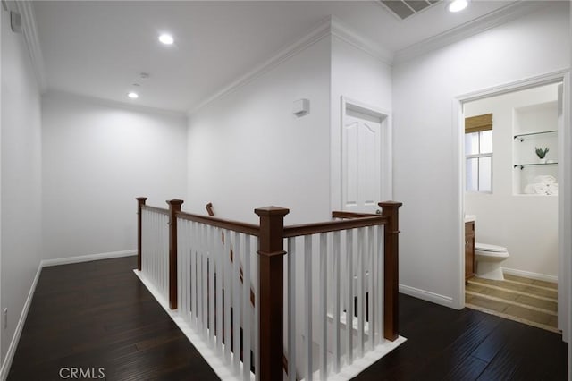 corridor with hardwood / wood-style flooring, ornamental molding, visible vents, an upstairs landing, and recessed lighting