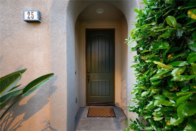 view of exterior entry with stucco siding