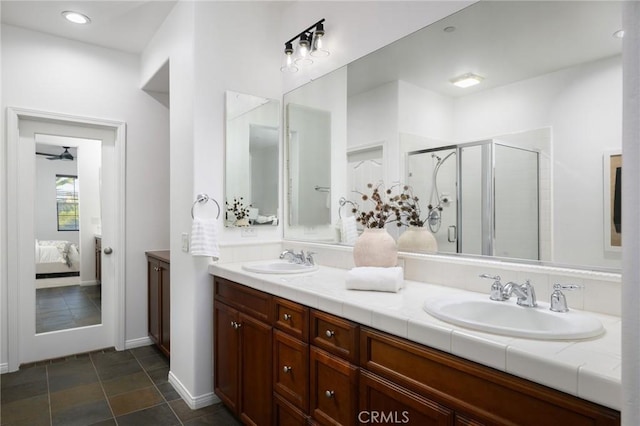 full bathroom featuring a sink, double vanity, ensuite bath, and a shower stall