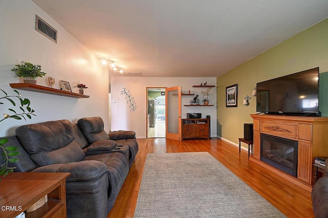 2030 Lomita Park Pl, Lomita, CA 90717 - living room featuring a glass covered fireplace, visible vents, and light wood-style floors