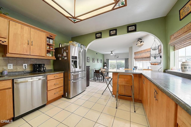 2030 Lomita Park Pl, Lomita, CA 90717 - kitchen featuring tasteful backsplash, open shelves, arched walkways, and appliances with stainless steel finishes