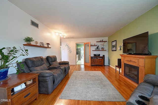2030 Lomita Park Pl, Lomita, CA 90717 - living room with light wood finished floors, a glass covered fireplace, and visible vents