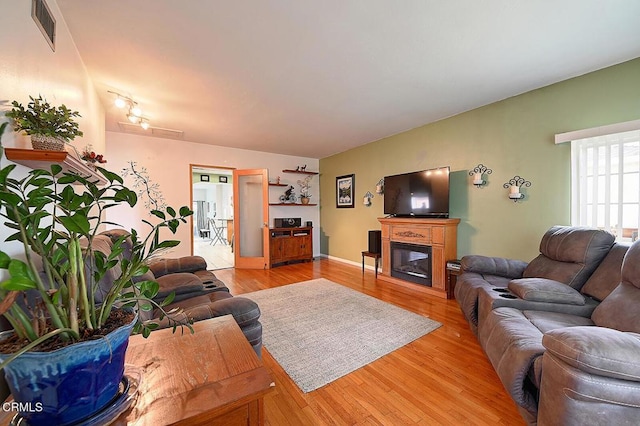 2030 Lomita Park Pl, Lomita, CA 90717 - living area with light wood-style floors and a glass covered fireplace