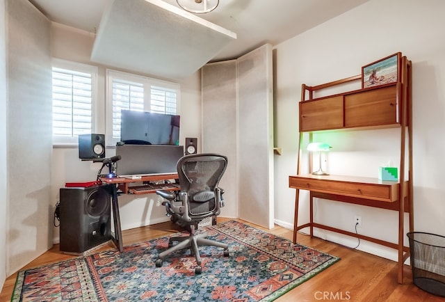 office space featuring baseboards and wood finished floors