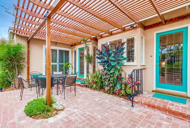 view of patio featuring a pergola and outdoor dining space