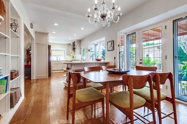 dining area featuring light wood-style floors, a chandelier, and recessed lighting