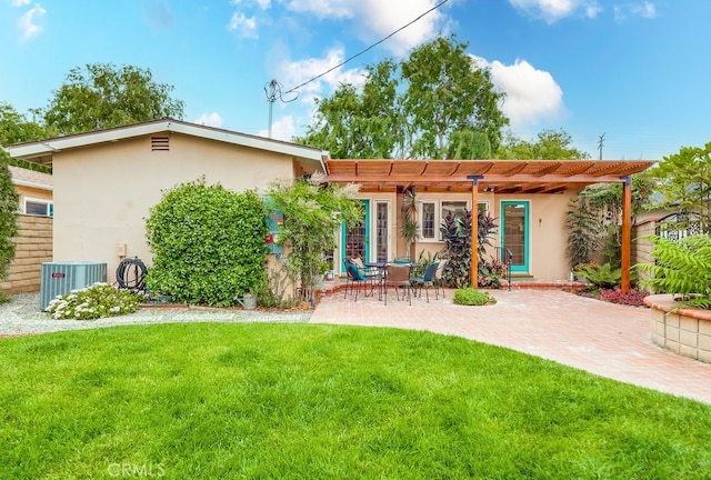 back of house with central AC, stucco siding, a pergola, a lawn, and a patio area