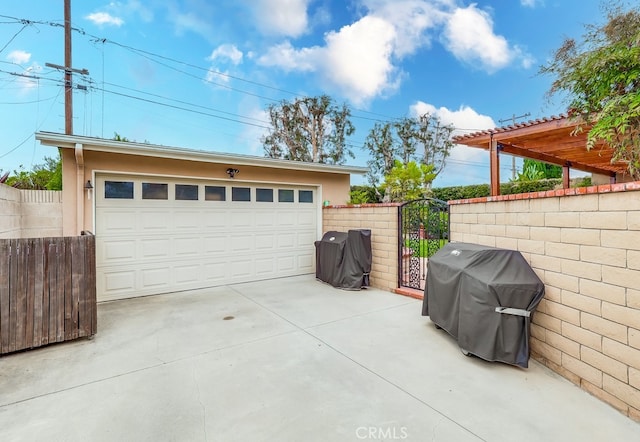 detached garage featuring a gate and fence