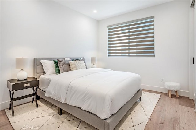 bedroom with light wood-style flooring, baseboards, and recessed lighting