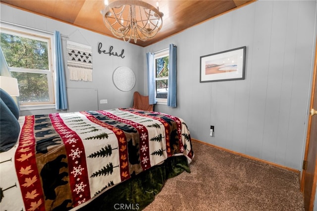 carpeted bedroom featuring a chandelier