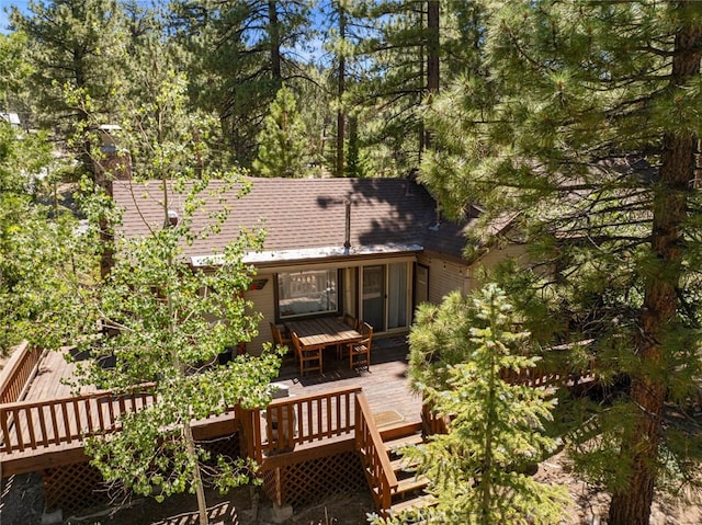 rear view of house featuring a deck