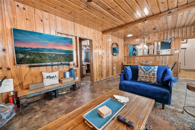 living room with stone finish floor, a notable chandelier, wood walls, beamed ceiling, and wooden ceiling