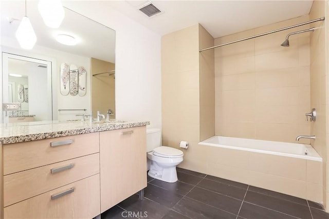 full bathroom featuring toilet, vanity, visible vents, tile patterned floors, and tub / shower combination