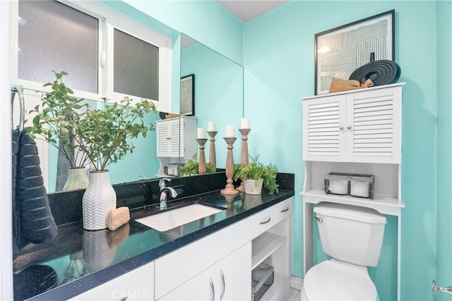 bathroom featuring toilet and vanity