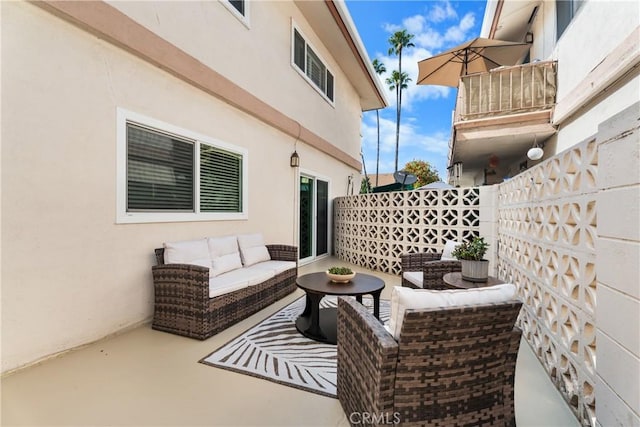 view of patio / terrace featuring outdoor lounge area and fence