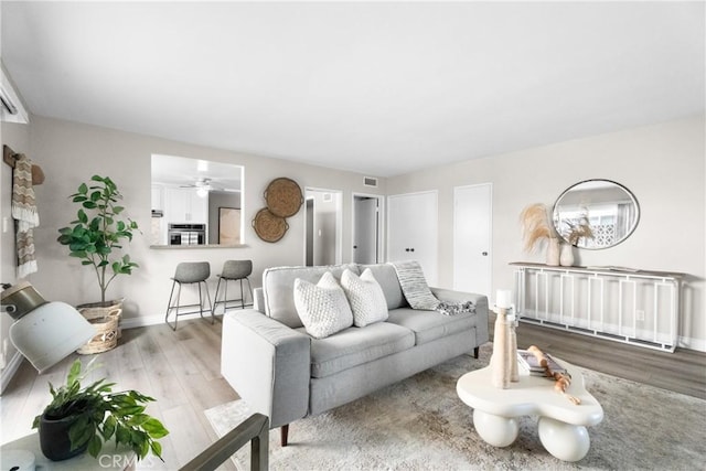 living area with baseboards and light wood-style floors