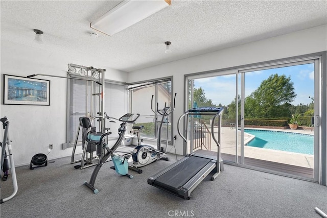 exercise room featuring a textured ceiling