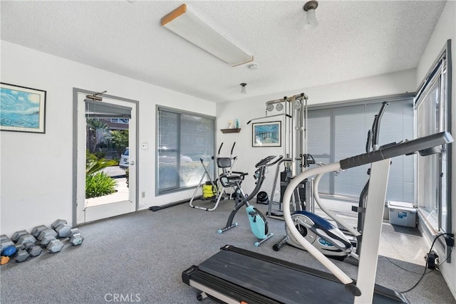 workout area featuring a textured ceiling