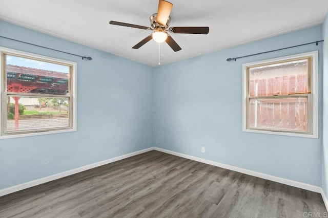 unfurnished room with baseboards, a ceiling fan, and wood finished floors