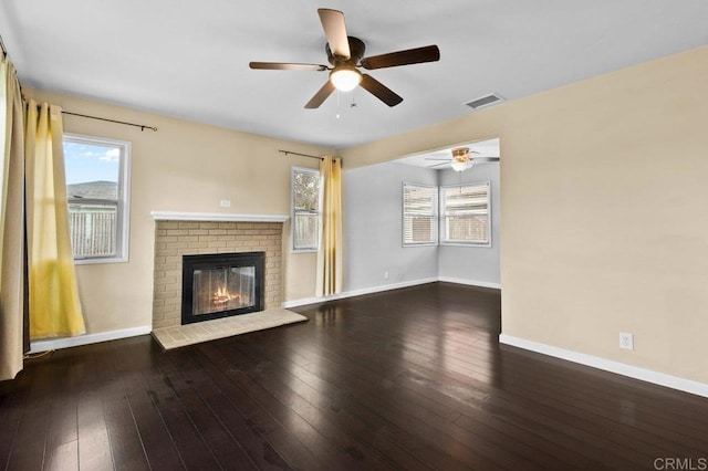 unfurnished living room featuring baseboards, a healthy amount of sunlight, and ceiling fan