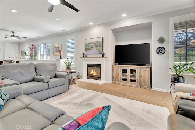 living room with crown molding, ceiling fan, and recessed lighting