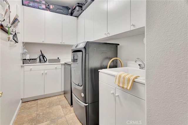 2673 Traditions Loop, Paso Robles, CA 93446 - laundry room featuring cabinet space, washer / clothes dryer, baseboards, and light stone finish flooring