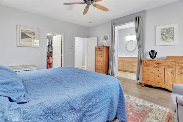 2673 Traditions Loop, Paso Robles, CA 93446 - bedroom featuring light wood-style flooring, a walk in closet, ensuite bathroom, a ceiling fan, and a closet