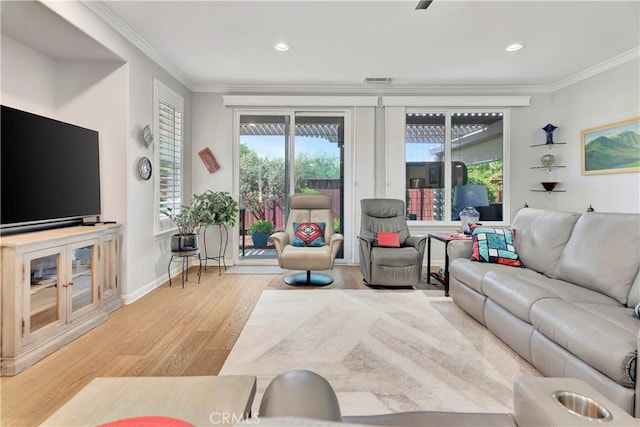living room with ornamental molding, recessed lighting, and wood finished floors