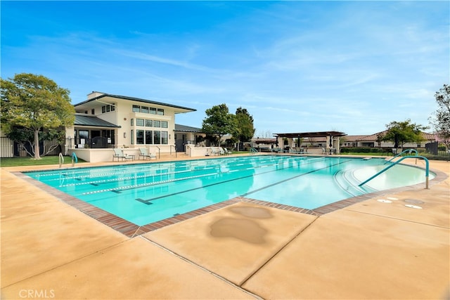 community pool with a pergola, fence, and a patio