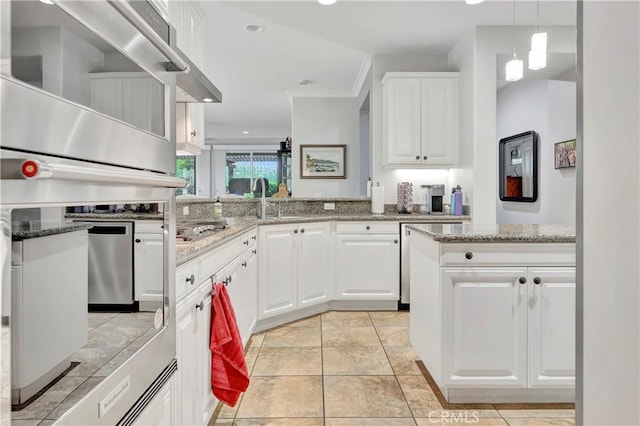 kitchen featuring light stone countertops, decorative light fixtures, white cabinetry, and recessed lighting