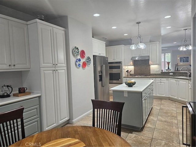 2673 Traditions Loop, Paso Robles, CA 93446 - kitchen featuring stainless steel appliances, a sink, a kitchen island, recessed lighting, and under cabinet range hood