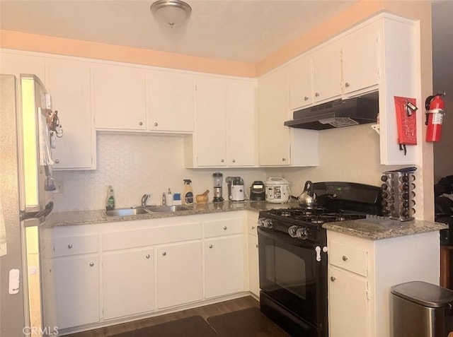 4700 Clair Del Ave Unit 620, Long Beach, CA 90807 - kitchen featuring gas stove, under cabinet range hood, freestanding refrigerator, and white cabinetry