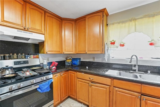49604962 Gambier St, Los Angeles, CA 90032 - kitchen featuring stainless steel gas range oven, under cabinet range hood, a sink, dark stone counters, and light tile patterned floors