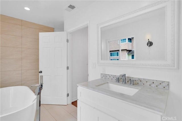 3564 Poppy Dr, Calabasas, CA 91302 - bathroom featuring tile patterned floors, tile walls, visible vents, a freestanding tub, and vanity