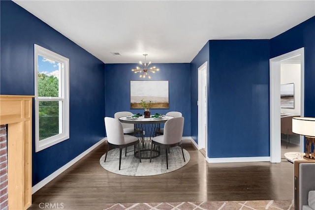 13023 Woodcock Ave, Sylmar, CA 91342 - dining space with a chandelier, wood finished floors, and baseboards