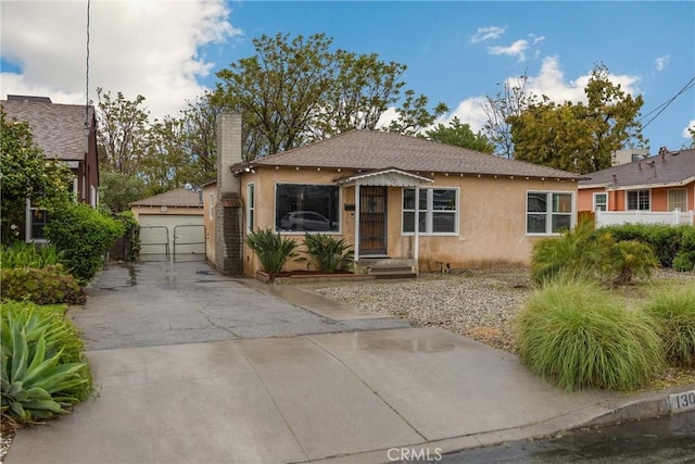 13023 Woodcock Ave, Sylmar, CA 91342 - bungalow-style home featuring stucco siding, a chimney, roof with shingles, and an outdoor structure