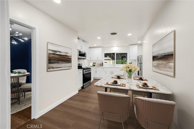 13023 Woodcock Ave, Sylmar, CA 91342 - dining space featuring dark wood-type flooring, recessed lighting, and baseboards