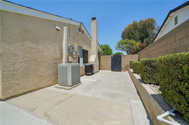 6253 Hamilton Ct, Chino, CA 91710 - view of patio with central air condition unit and a gate