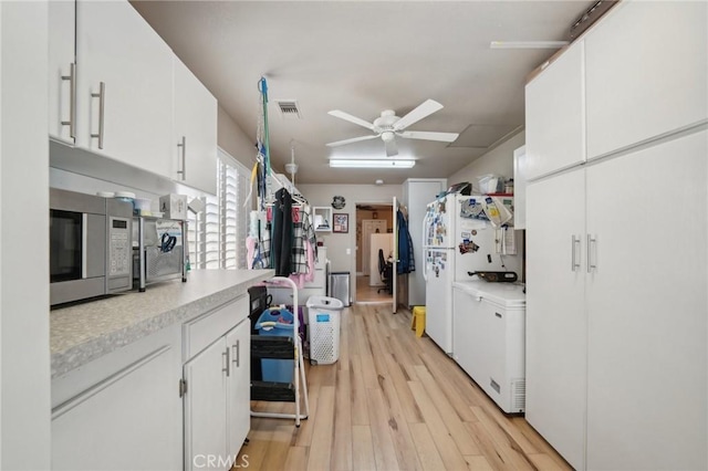 6253 Hamilton Ct, Chino, CA 91710 - kitchen featuring light countertops, light wood-style flooring, ceiling fan, and white cabinetry