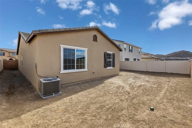 29079 Laramie Ct, Winchester, CA 92596 - back of house featuring cooling unit, a fenced backyard, and stucco siding