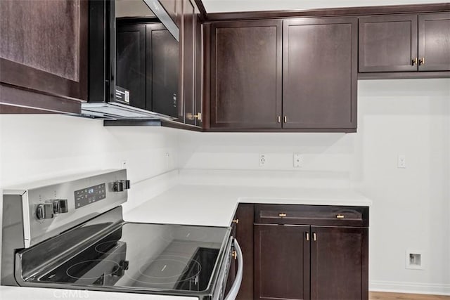29079 Laramie Ct, Winchester, CA 92596 - kitchen with electric stove, dark brown cabinets, and light countertops