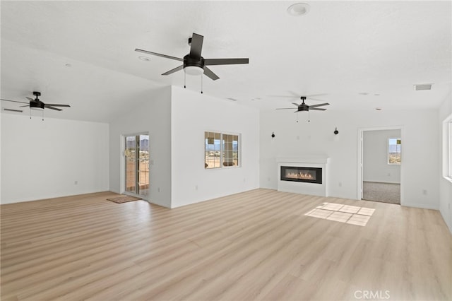 16925 Nanticoke Rd, Apple Valley, CA 92307 - unfurnished living room featuring light wood-type flooring, visible vents, a glass covered fireplace, and ceiling fan