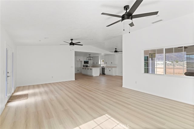 16925 Nanticoke Rd, Apple Valley, CA 92307 - unfurnished living room featuring visible vents, vaulted ceiling, a ceiling fan, baseboards, and light wood-style floors