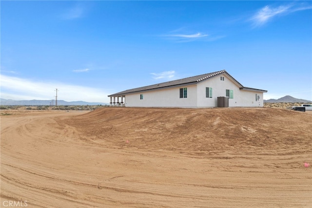 16925 Nanticoke Rd, Apple Valley, CA 92307 - exterior space with central air condition unit, stucco siding, and a mountain view