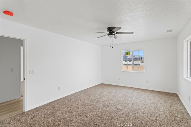 16925 Nanticoke Rd, Apple Valley, CA 92307 - spare room featuring a ceiling fan, light carpet, visible vents, and baseboards