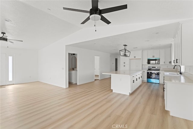 16925 Nanticoke Rd, Apple Valley, CA 92307 - kitchen featuring a sink, stainless steel appliances, ceiling fan, open floor plan, and light countertops