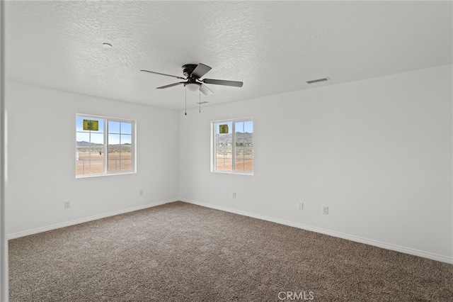 16925 Nanticoke Rd, Apple Valley, CA 92307 - carpeted empty room featuring a textured ceiling, visible vents, baseboards, and a ceiling fan