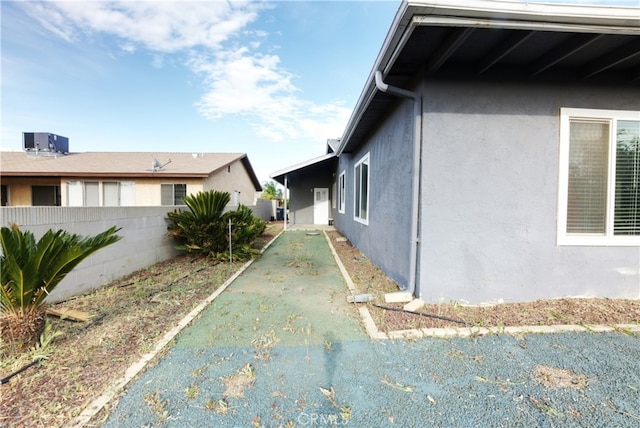 26376 Mahaffey, Menifee, CA 92586 - view of side of property with stucco siding, central AC unit, and fence