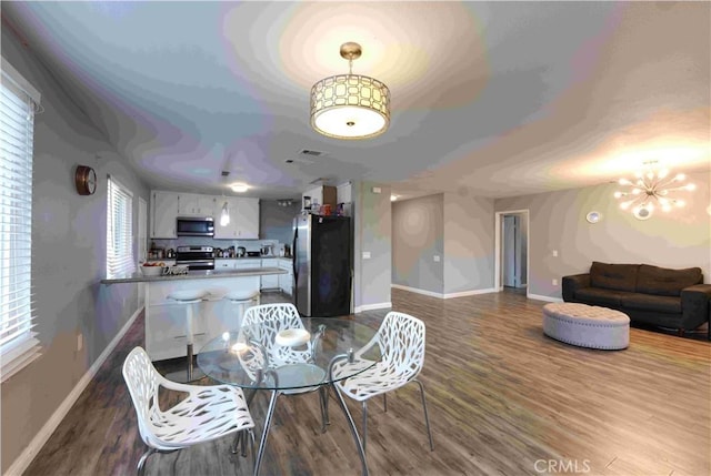 26376 Mahaffey, Menifee, CA 92586 - dining room with baseboards, dark wood-style floors, plenty of natural light, and a chandelier