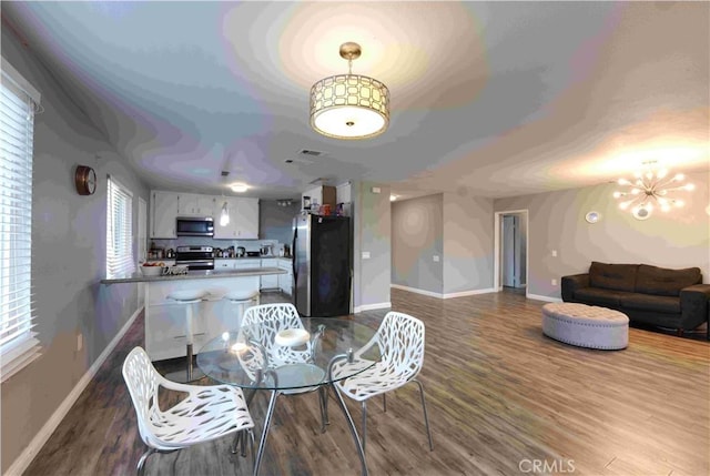 26376 Mahaffey, Menifee, CA 92586 - dining area with dark wood-style floors, healthy amount of natural light, and a chandelier